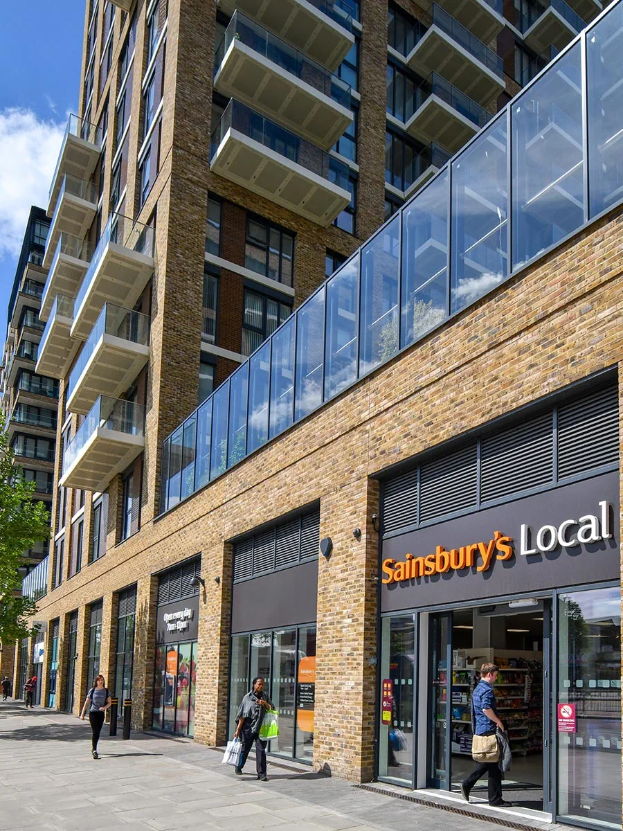 Sainsbury's Local store under a residential building, UK.