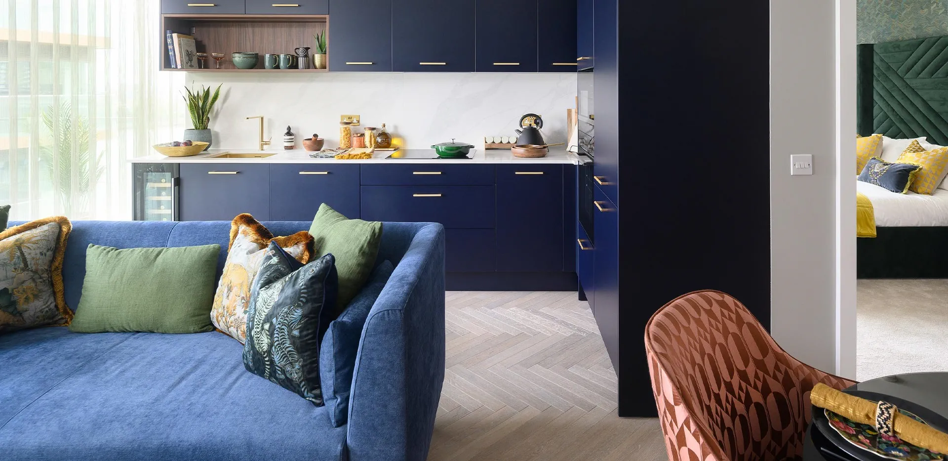 Cozy blue sofa with colorful pillows in a modern living space.