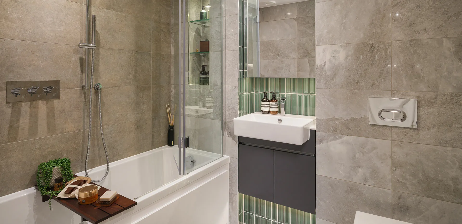 Luxury bathroom featuring green vertical feature tiles, bathtub overhead shower, and modern vanity.