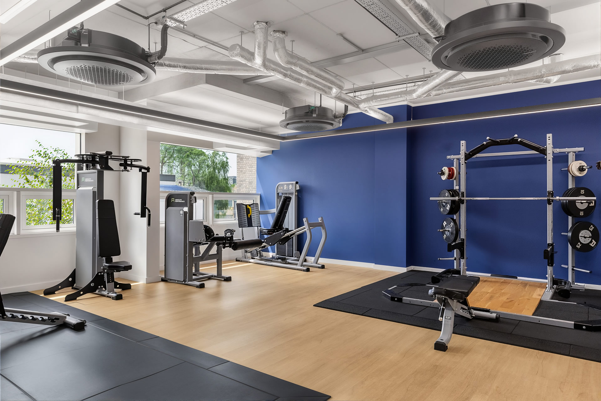 Luxury residential fitness center with weightlifting equipment and modern gym facilities Luxury residential fitness center with weightlifting equipment and modern gym facilities