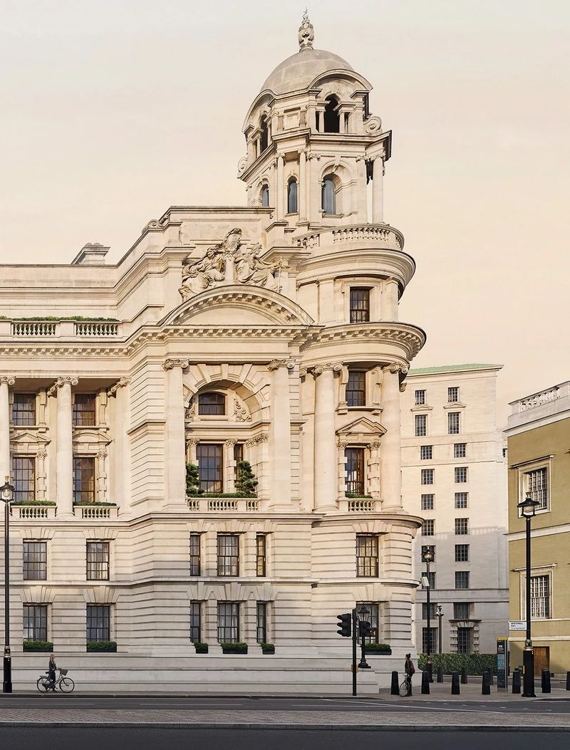 Detailed architectural view of the corner tower at The OWO, showcasing its ornate stone carvings.
